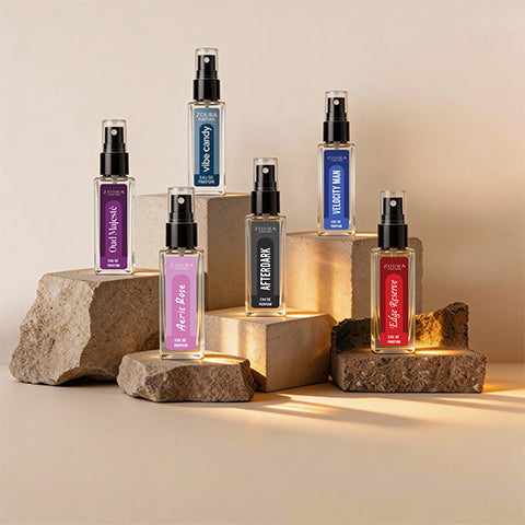 Collection of perfume bottles on stone and wooden platforms with a warm glow.
