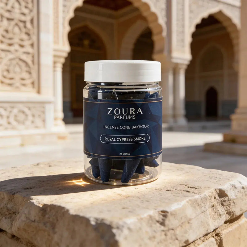Zoura Parfums incense cone packaging on a stone surface with architectural background