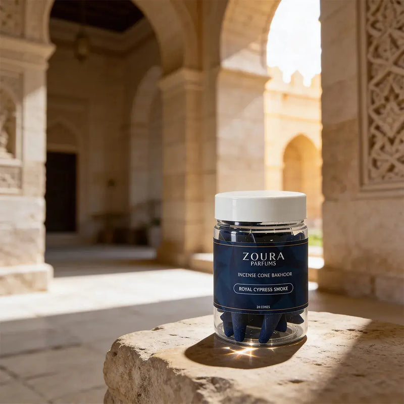 Zoura Parfums incense cone container on a stone surface with architectural background