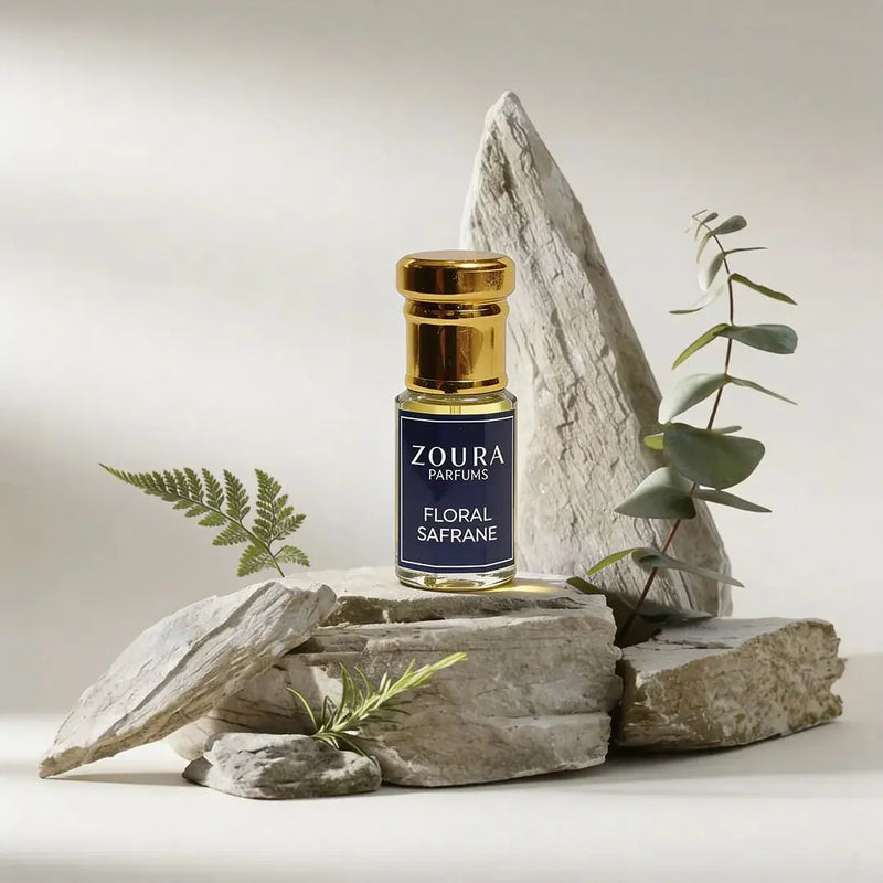 Zoura Floral Safrane Attar bottle on stone with greenery – fresh unisex attar
