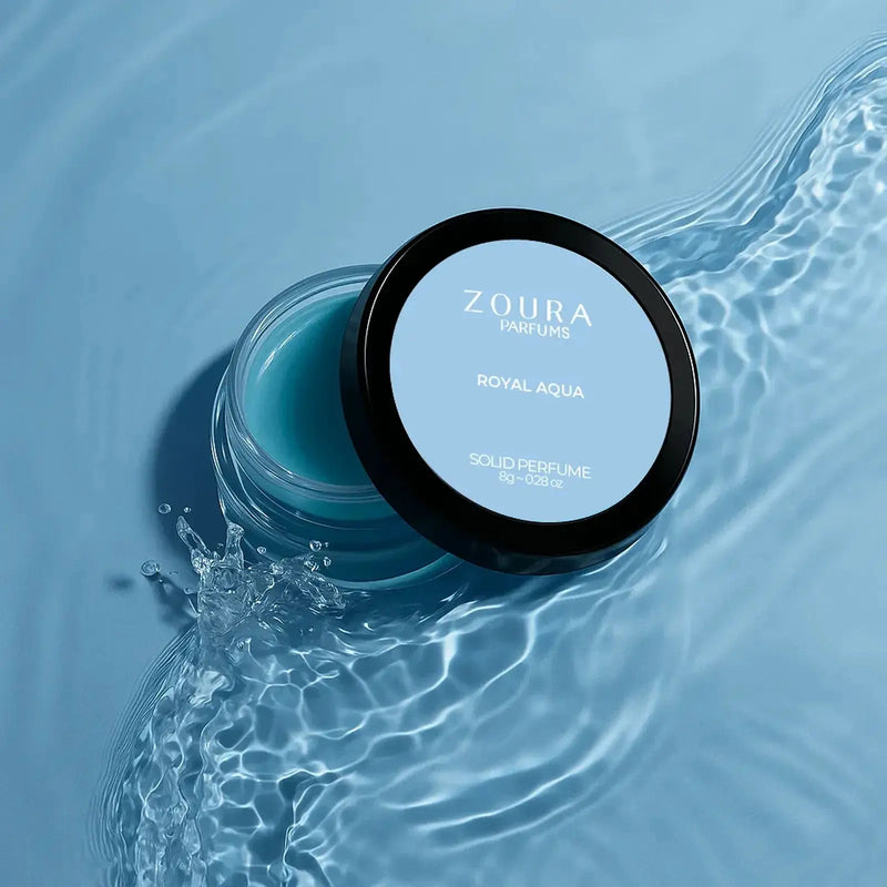 Zoura Royal Aqua Solid Perfume open jar with water splash