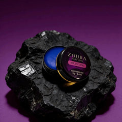 Zoura Wild Code Solid Perfume open jar on black rock