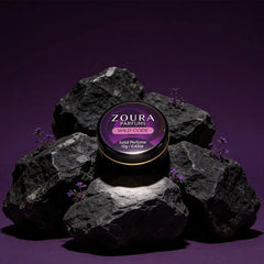 Zoura Wild Code Solid Perfume jar on purple rocks
