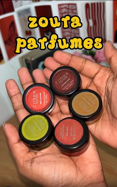 Hand holding five Zoura Parfums solid perfume jars including Red Affair and Lavish Oud, "Zoura Parfumes" showcase video.