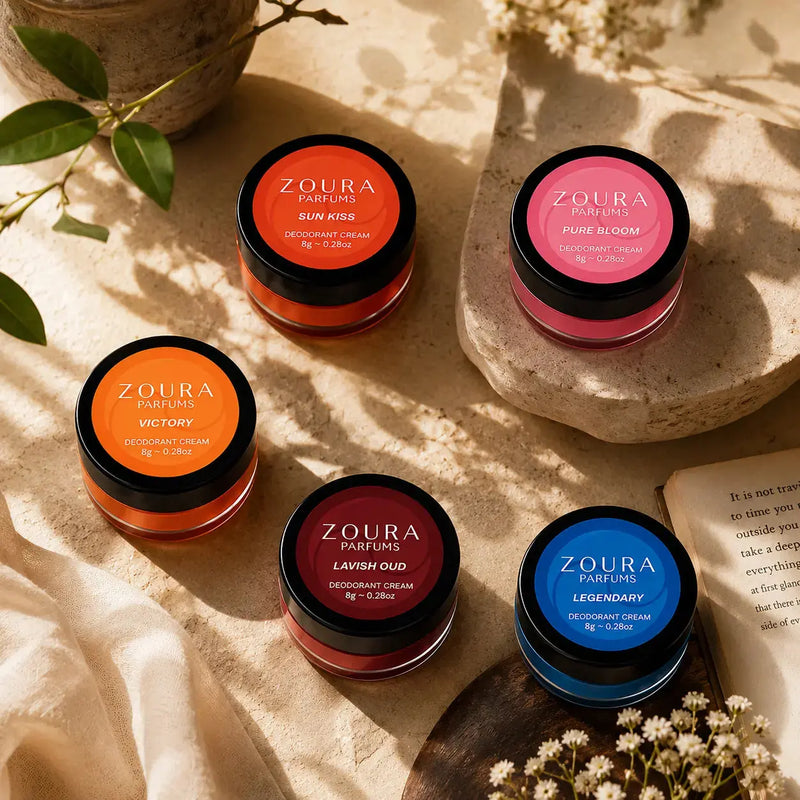 Zoura Discovery Deo Cream Collection styled on stone with florals – Sun Kiss, Pure Bloom, Victory, Lavish Oud, and Legendary natural deodorant cream jars