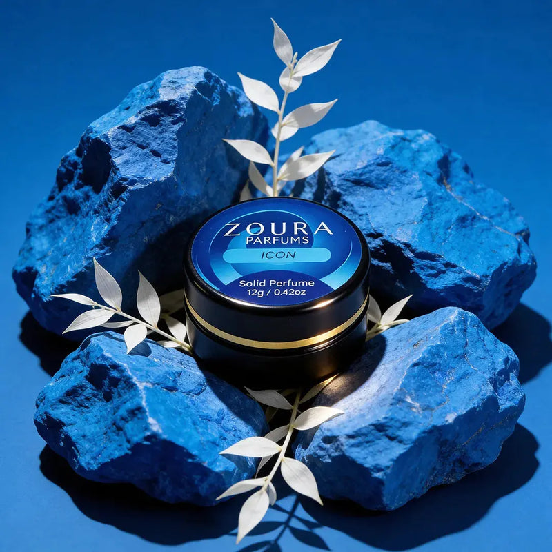Zoura Icon Unisex Solid Perfume jar surrounded by blue stones and silver leaves