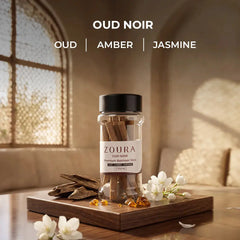 Zoura Oud Noir bakhoor sticks jar with oud, amber, and jasmine notes styled with jasmine flowers and oud wood