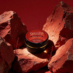 Zoura Royal Oud Unisex Solid Perfume jar nestled between red rocks