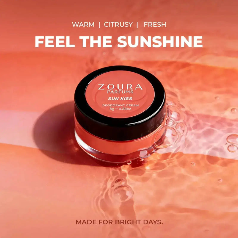 Zoura Sun Kiss natural deodorant cream – warm, citrusy, fresh fragrance jar on orange water backdrop, "Feel the Sunshine"